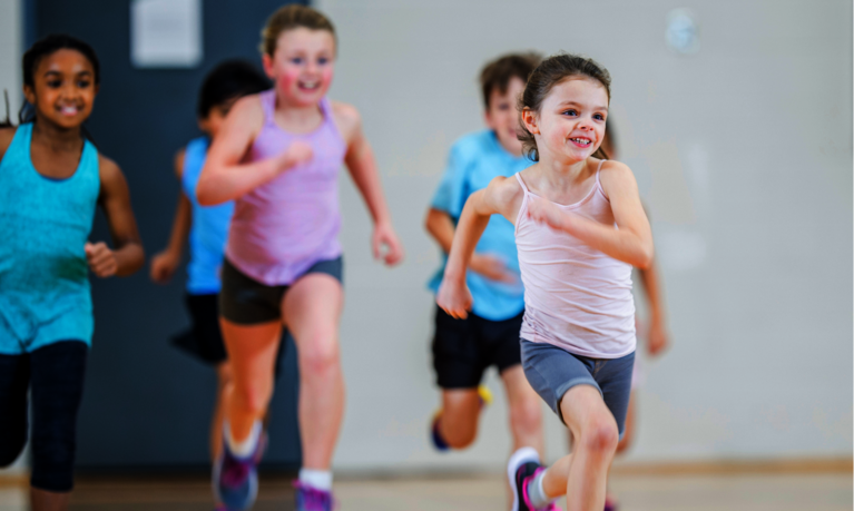 Kinder laufen durch die Sporthalle.